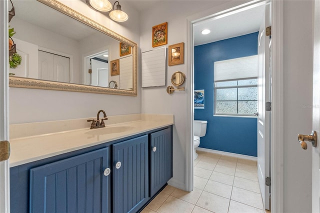 bathroom featuring toilet, tile patterned floors, and vanity