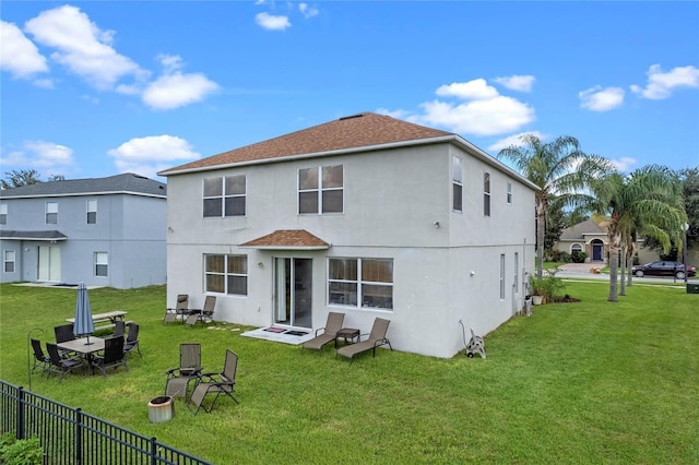 rear view of property featuring a yard