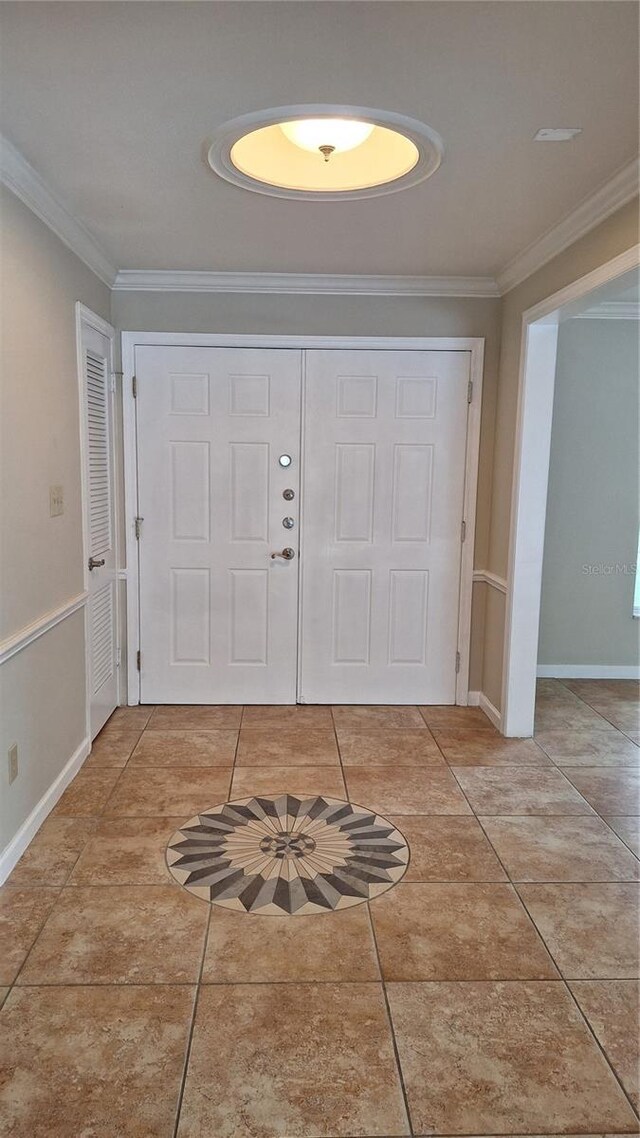 entryway featuring tile patterned flooring and crown molding