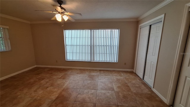 unfurnished bedroom featuring a textured ceiling, light tile patterned floors, crown molding, and ceiling fan