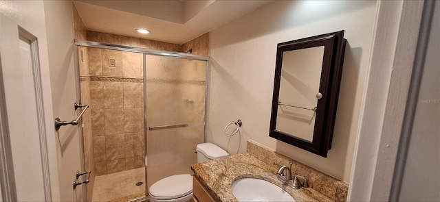 full bathroom with toilet, a shower stall, and vanity