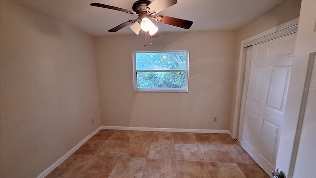 unfurnished bedroom featuring ceiling fan, a closet, and baseboards