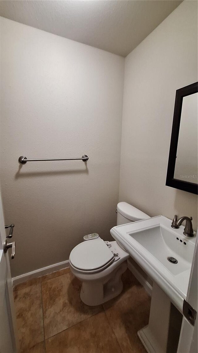 bathroom with tile patterned flooring and toilet