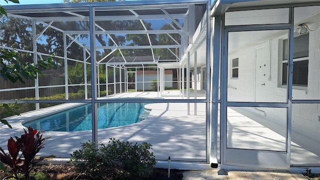 view of pool with a lanai, fence, a fenced in pool, and a patio