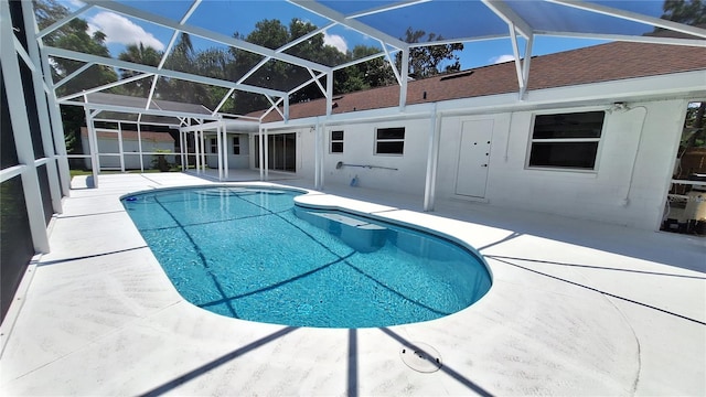 view of pool featuring a patio and glass enclosure