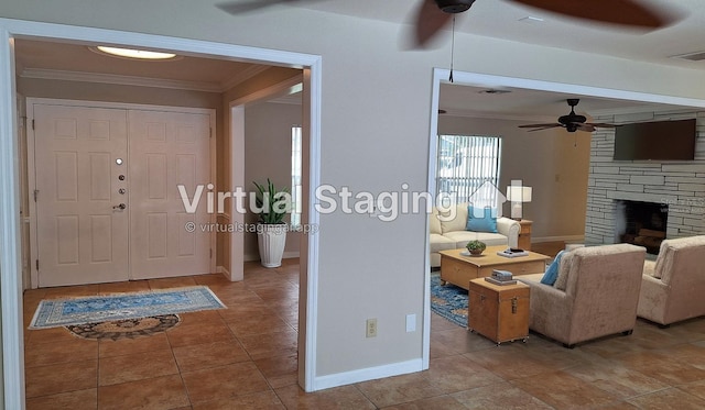 1030 Gregory Dr, Maitland, FL 32751 - foyer entrance featuring visible vents, ornamental molding, a stone fireplace, ceiling fan, and tile patterned floors