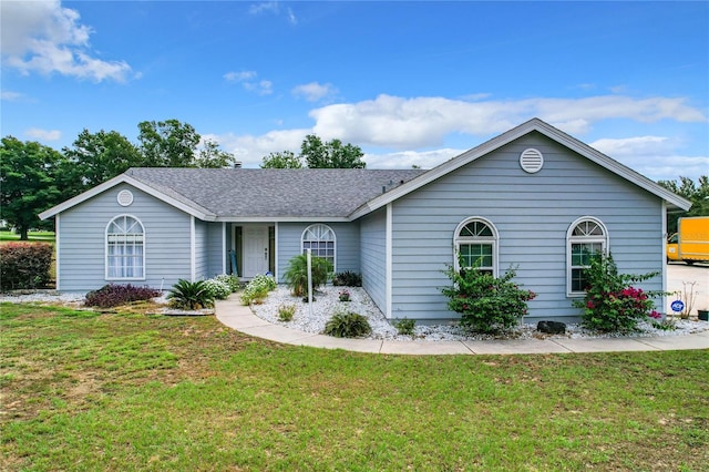 ranch-style home featuring a front lawn