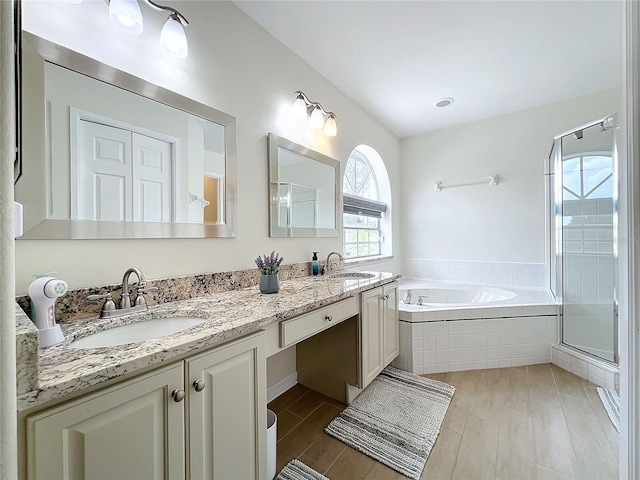 bathroom with shower with separate bathtub and vanity