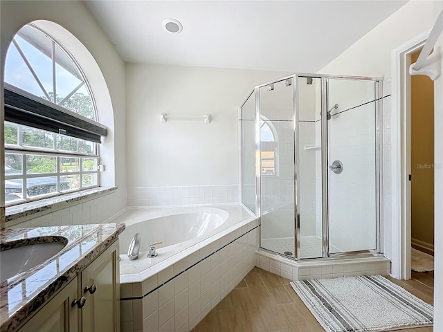 bathroom with vanity and independent shower and bath