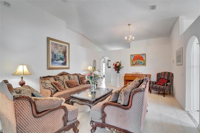 tiled living room featuring a notable chandelier and lofted ceiling