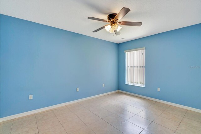 unfurnished room with ceiling fan and light tile floors