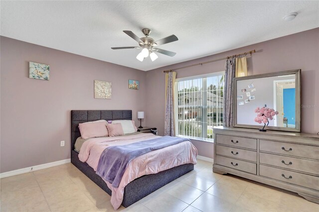 tiled bedroom featuring ceiling fan