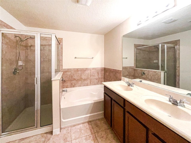 bathroom featuring vanity, a textured ceiling, tile patterned floors, and independent shower and bath