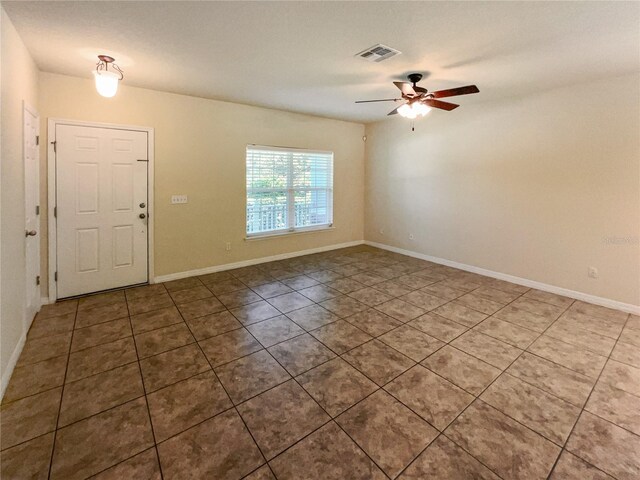 tiled entrance foyer featuring ceiling fan