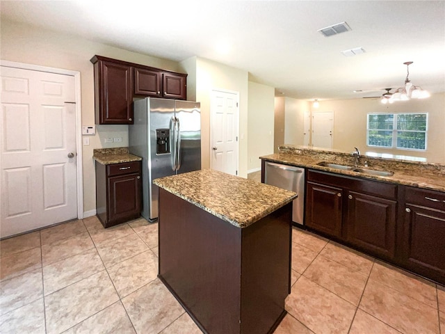 kitchen featuring a center island, sink, dark brown cabinetry, and stainless steel appliances