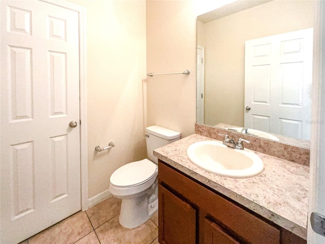 bathroom featuring tile patterned floors, vanity, and toilet