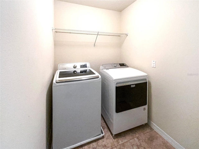 washroom featuring tile patterned flooring and washing machine and clothes dryer