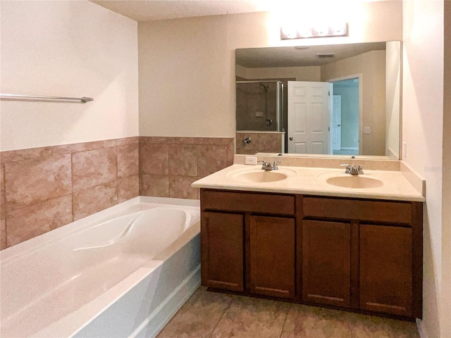 bathroom featuring tile patterned flooring, vanity, and independent shower and bath