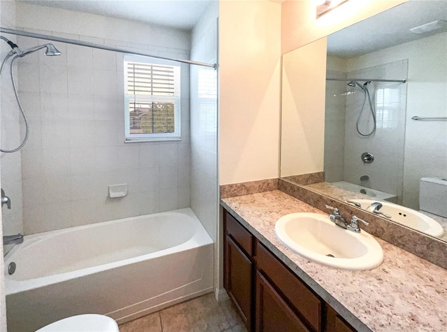 full bathroom with tile patterned flooring, vanity, toilet, and tiled shower / bath