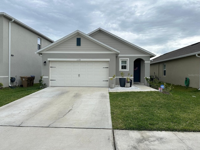 view of front of property with a front yard and a garage