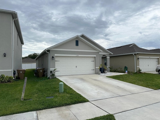 ranch-style house featuring a front lawn and a garage