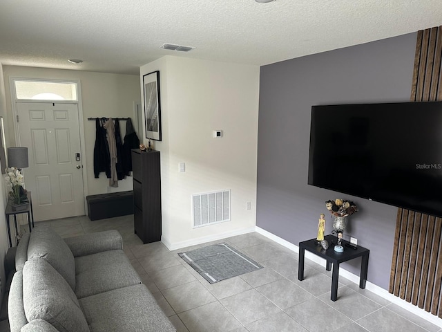 tiled living room with a textured ceiling