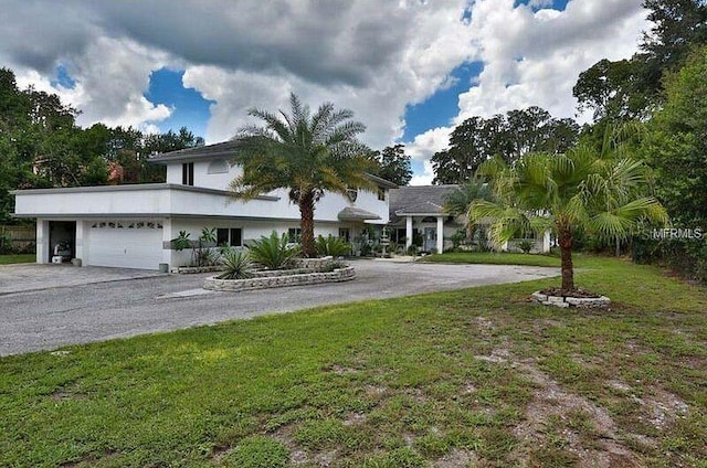 view of front of home with a garage and a front yard