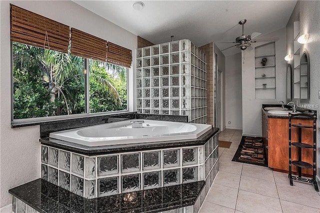 bathroom featuring a ceiling fan, a garden tub, tile patterned flooring, walk in shower, and vanity