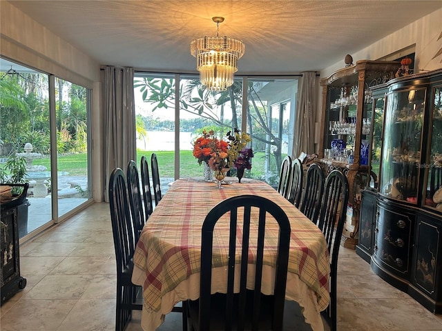 dining room featuring a wealth of natural light and a notable chandelier