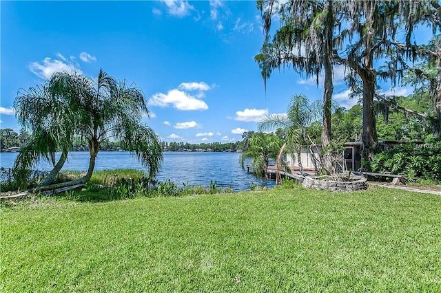 dock area featuring a water view and a yard