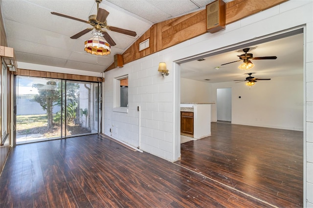 empty room featuring ceiling fan, hardwood / wood-style flooring, and vaulted ceiling