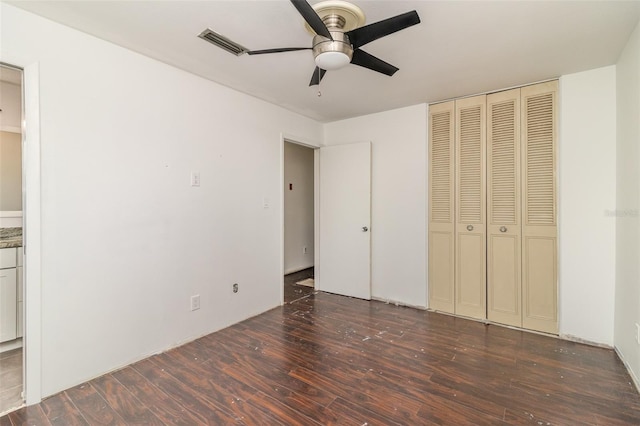 unfurnished bedroom featuring ceiling fan, hardwood / wood-style floors, and a closet