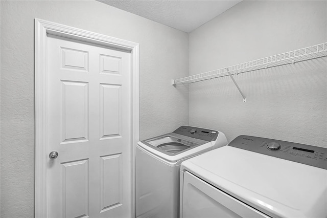 clothes washing area with separate washer and dryer