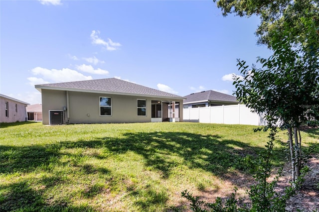 rear view of house featuring a yard