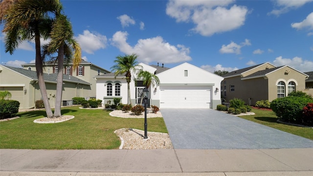 mediterranean / spanish-style house featuring a garage and a front lawn