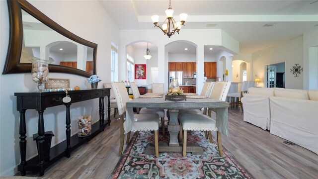 dining room featuring hardwood / wood-style flooring and a chandelier