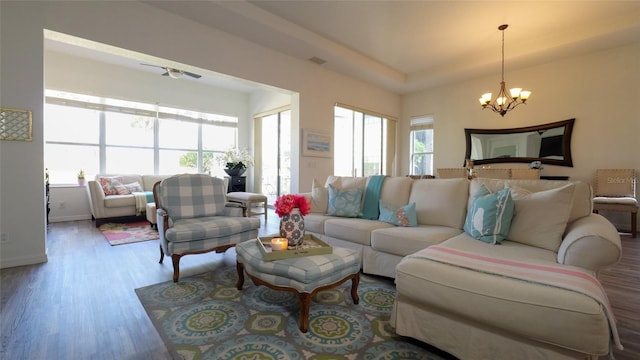 living room featuring hardwood / wood-style flooring and an inviting chandelier