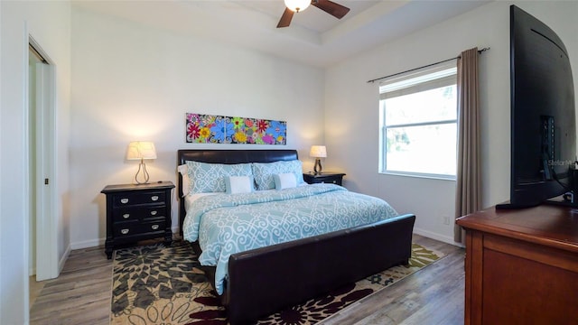 bedroom with ceiling fan and hardwood / wood-style floors