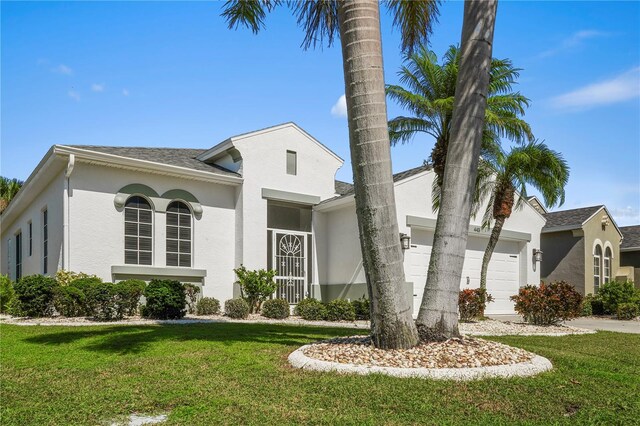 view of front facade with a front yard and a garage