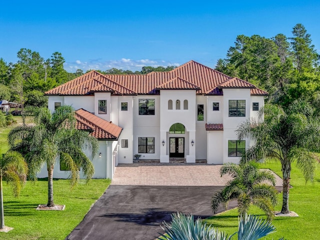 mediterranean / spanish-style house with a front lawn