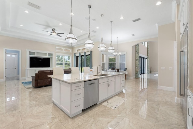 kitchen featuring stainless steel dishwasher, white cabinetry, a raised ceiling, and a kitchen island with sink