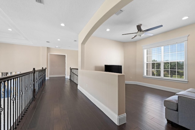 hallway featuring dark hardwood / wood-style flooring and a textured ceiling