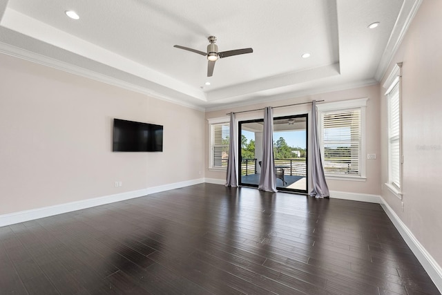 unfurnished living room with dark hardwood / wood-style floors, a raised ceiling, and ceiling fan