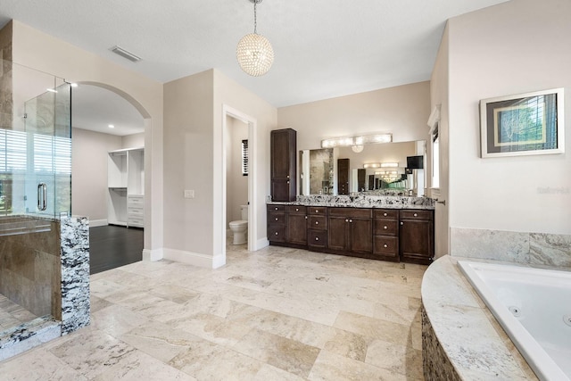 full bathroom featuring a textured ceiling, toilet, vanity, tile patterned floors, and separate shower and tub