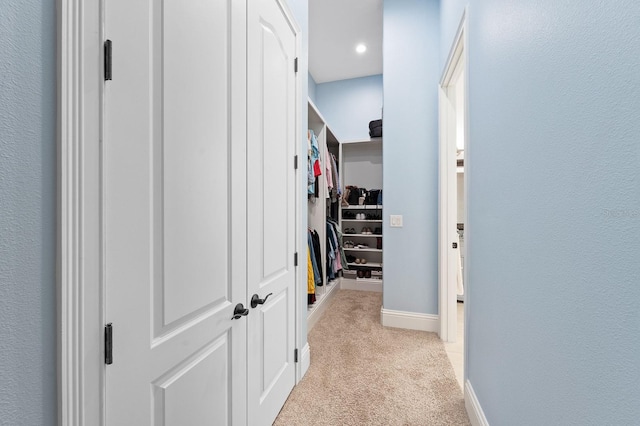 hallway featuring light carpet