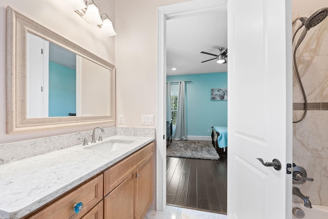 bathroom featuring tiled shower / bath combo, vanity, wood-type flooring, and ceiling fan