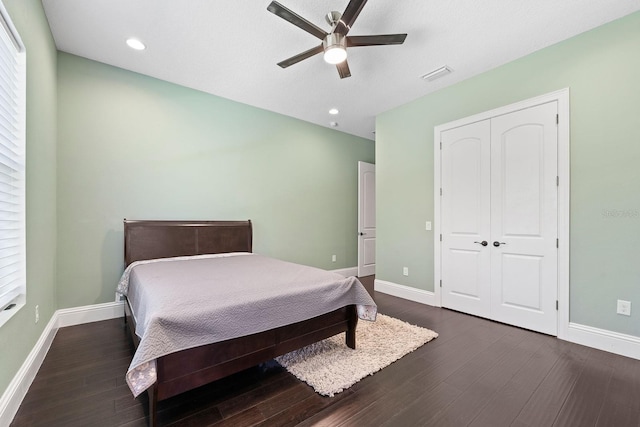 bedroom with a closet, ceiling fan, and dark hardwood / wood-style floors