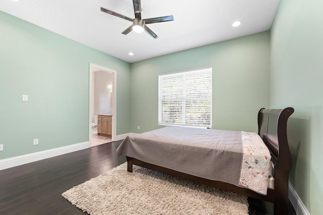 bedroom featuring wood-type flooring, ceiling fan, and connected bathroom