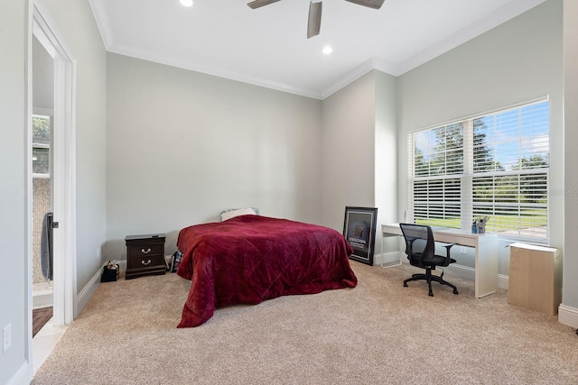 carpeted bedroom featuring crown molding, ensuite bathroom, and ceiling fan