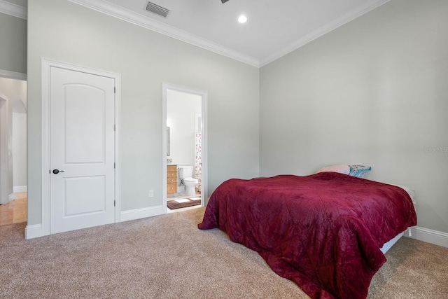 bedroom featuring carpet flooring, ensuite bath, and ornamental molding